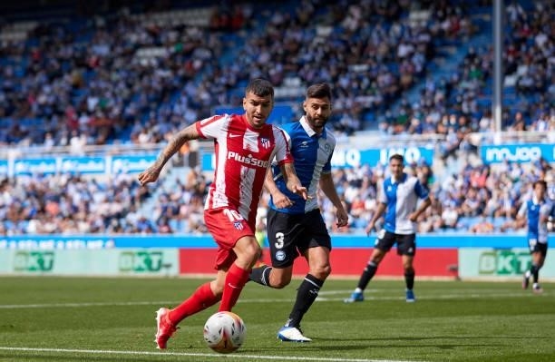 Ruben Duarte of Deportivo Alaves competes for the ball with Angel Correa of Club Atletico de Madrid during the La Liga Santander match between...