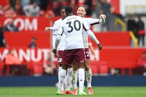 Matty Cash of Aston Villa and Kortney Hause of Aston Villa celebrate their sides win following the Premier League match between Manchester United and...