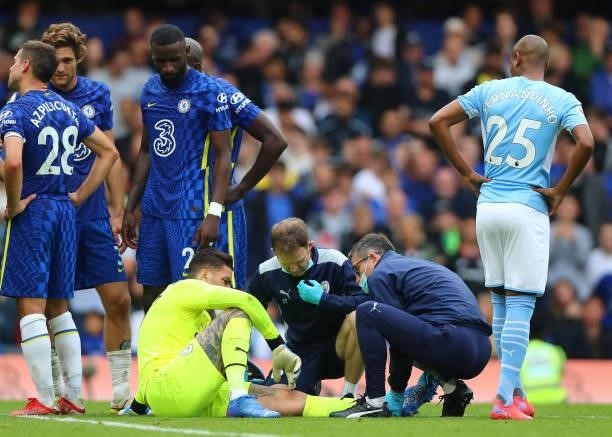 Ederson Moraes of Manchester City receives medical attention after a collision during the Premier League match between Chelsea and Manchester City at...