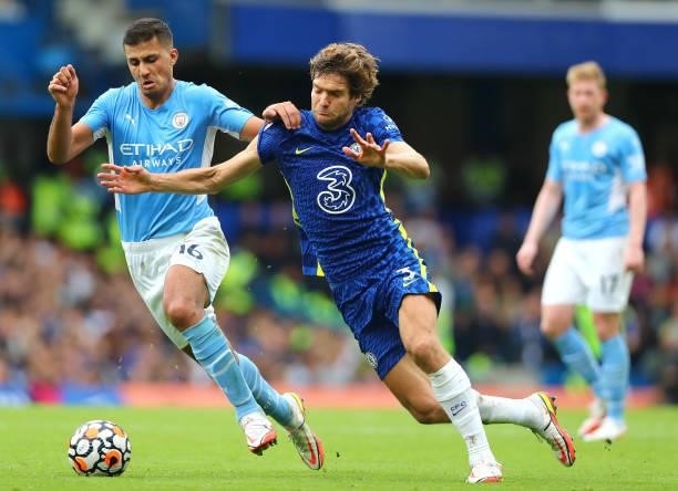 Rodrigo of Manchester City and Marcos Alonso of Chelsea battle for the ball during the Premier League match between Chelsea and Manchester City at...