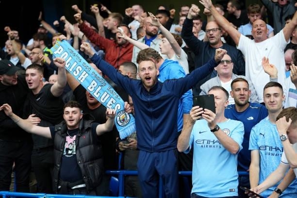 Manchester City fans celebrate their sides win following the Premier League match between Chelsea and Manchester City at Stamford Bridge on September...