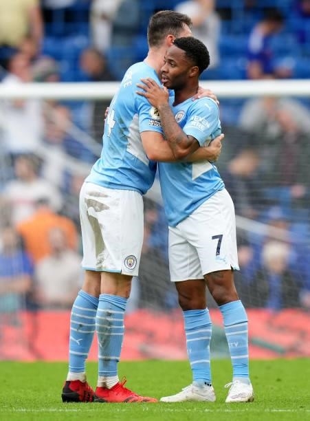 Aymeric Laporte and Raheem Sterling of Manchester City embrace following their team's victory in the Premier League match between Chelsea and...
