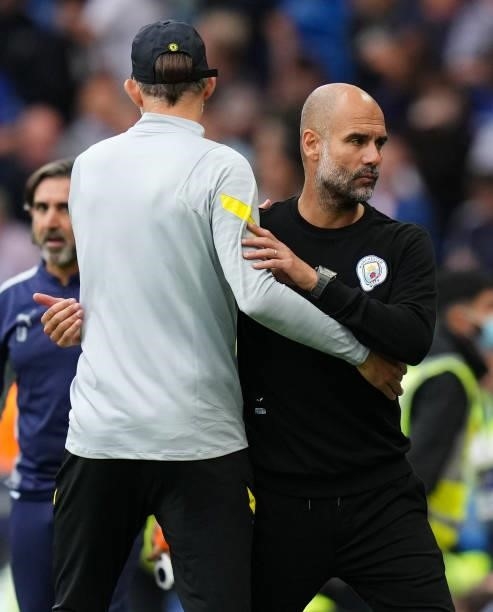 Pep Guardiola, Manager of Manchester City interacts with Thomas Tuchel, Manager of Chelsea after the Premier League match between Chelsea and...