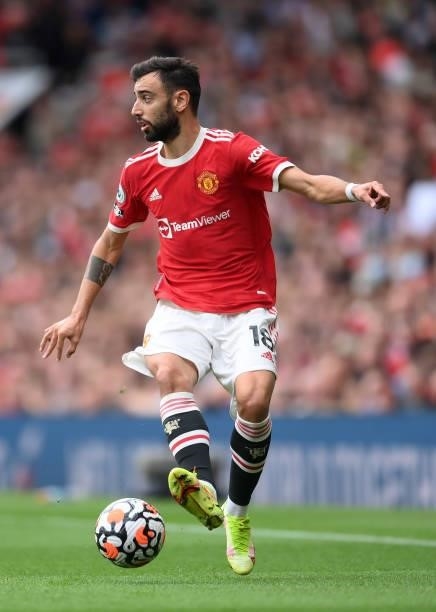Bruno Fernandes runs with the ball during the Premier League match between Manchester United and Aston Villa at Old Trafford on September 25, 2021 in...