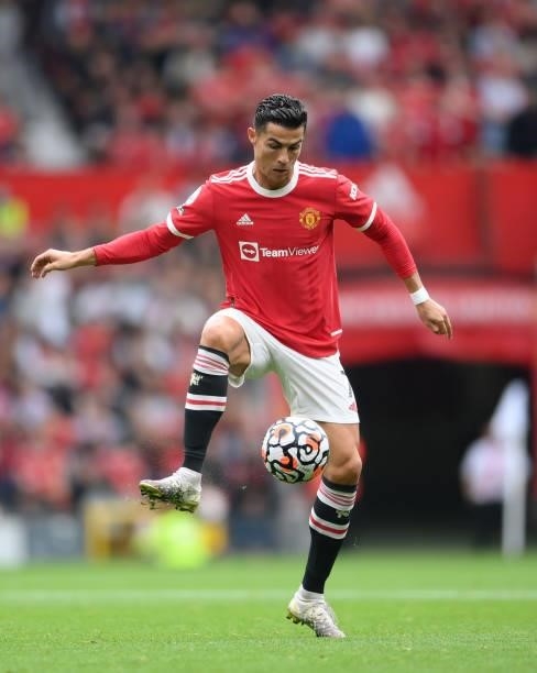 Cristiano Ronaldo runs with the ball during the Premier League match between Manchester United and Aston Villa at Old Trafford on September 25, 2021...