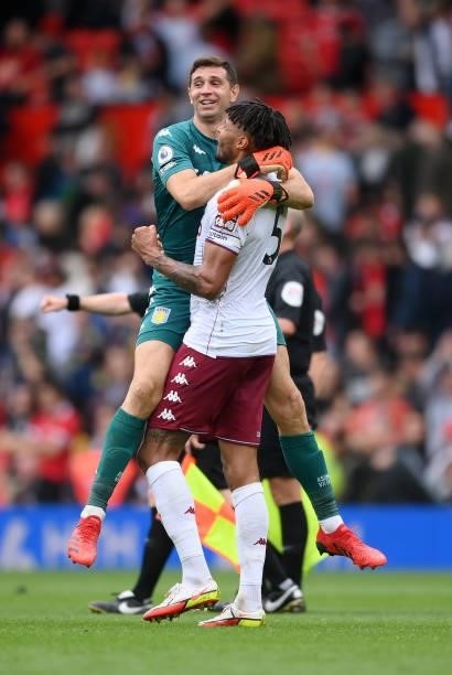Emiliano Martinez of Aston Villa celebrates with Tyrone Mings on the final whistle during the Premier League match between Manchester United and...