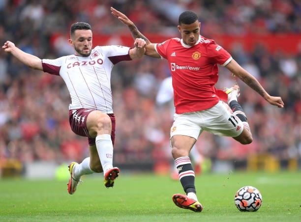 Mason Greenwood of Manchester United is tackled by John McGinn of Aston Villa during the Premier League match between Manchester United and Aston...