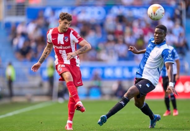 Mamadou Ndiaye of Deportivo Alaves competes for the ball with Sime Vrsaljko of Club Atletico de Madrid during the La Liga Santander match between...