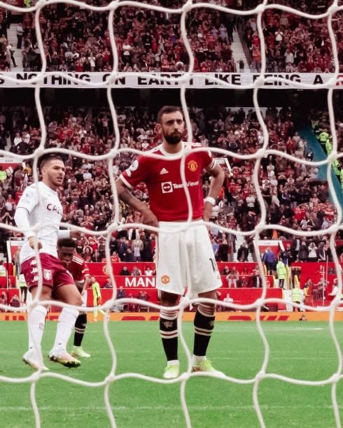 Bruno Fernandes of Manchester United reacts to missing a penalty during the Premier League match between Manchester United and Aston Villa at Old...
