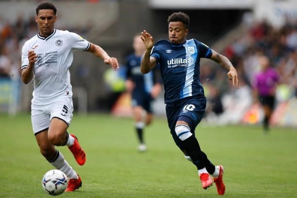 Josh Koroma of Huddersfield Town looks to run past Ben Cabango of Swansea City during the Sky Bet Championship match between Swansea City and...