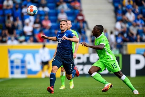 Pavel Kaderabek of TSG Hoffenheim and Jerome Roussillon of VfL Wolfsburg compete for the ball during the Bundesliga match between TSG Hoffenheim and...