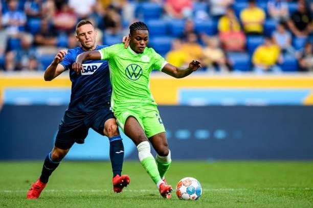 Pavel Kaderabek of TSG Hoffenheim and Ridle Baku of VfL Wolfsburg compete for the ball during the Bundesliga match between TSG Hoffenheim and VfL...