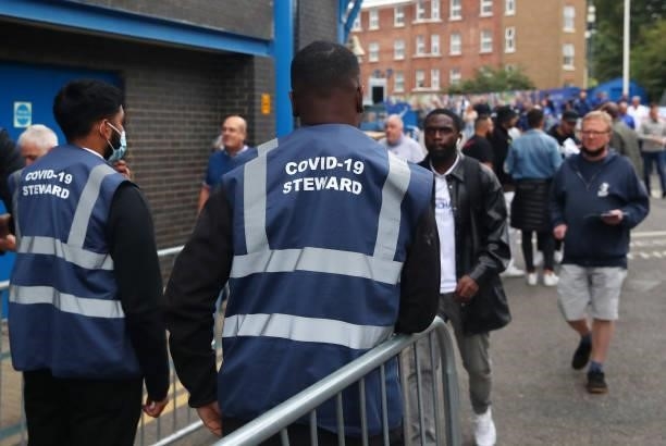 Stewards check the Covid status of fans as they arrive ahead of the Premier League match between Chelsea and Manchester City at Stamford Bridge on...