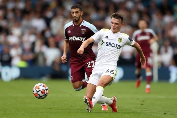 Jamie Shackleton of Leeds United passes the ball whilst under pressure from Said Benrahma of West Ham United during the Premier League match between...