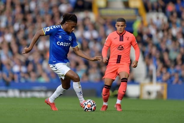 Alex Iwobi of Everton and Max Aarons challenge for the ball during the Premier League match between Everton and Norwich City at Goodison Park on...