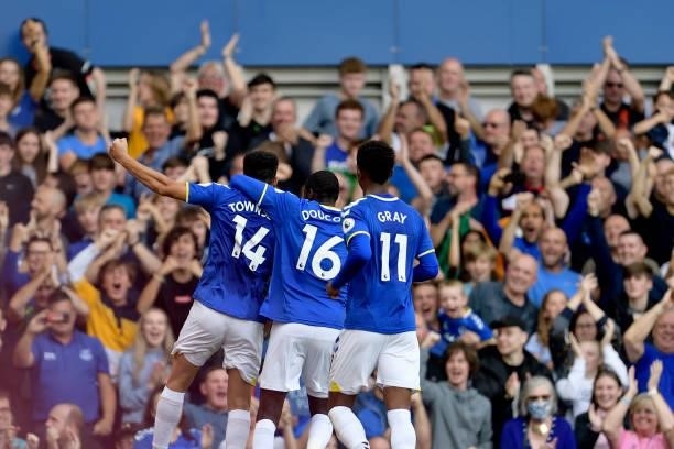 Andros Townsend of Everton celebrates his goal with Abdoulaye Doucoure and Demarai Gray during the Premier League match between Everton and Norwich...
