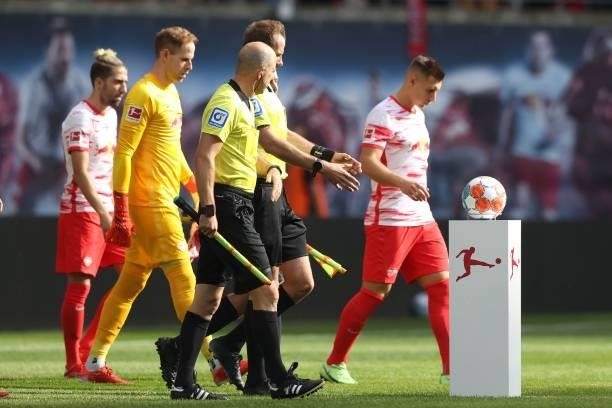 Players and Referees enter the field of play for the Bundesliga match between RB Leipzig and Hertha BSC at Red Bull Arena on September 25, 2021 in...