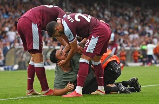 Pitch invader is seen celebrating their side's second goal with Tomas Soucek and Said Benrahma scored by Michail Antonio of West Ham United despite...