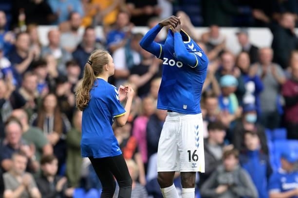 Abdoulaye Doucoure of Everton gives his shirt to a young fan after the Premier League match between Everton and Norwich City at Goodison Park on...