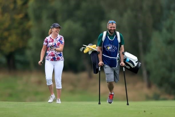 Hannah Burke of England walks to her second shot on the 18th hole with her caddie during the Rose Ladies Series Final at Bearwood Lakes Golf Club on...