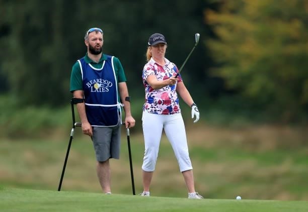 Hannah Burke of England walks to her second shot on the 18th hole with her caddie during the Rose Ladies Series Final at Bearwood Lakes Golf Club on...