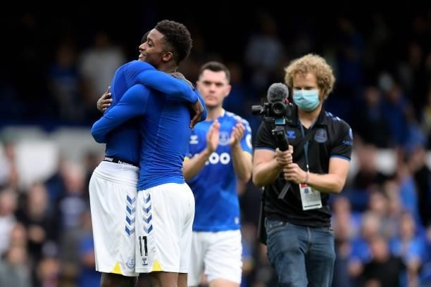 Demarai Gray of Everton embraces Abdoulaye Doucoure after the Premier League match between Everton and Norwich City at Goodison Park on September 25,...