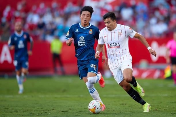 Marcos Acuña of Sevilla FC competes for the ball with Wu Lei of RCD Espanyol during the La Liga Santader match between Sevilla FC and RCD Espanyol at...