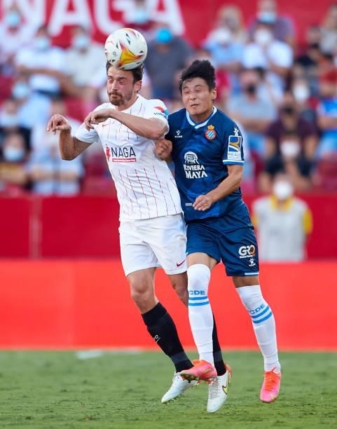 Thomas Delaney of Sevilla FC competes for the ball with Wu Lei of RCD Espanyol during the La Liga Santader match between Sevilla FC and RCD Espanyol...