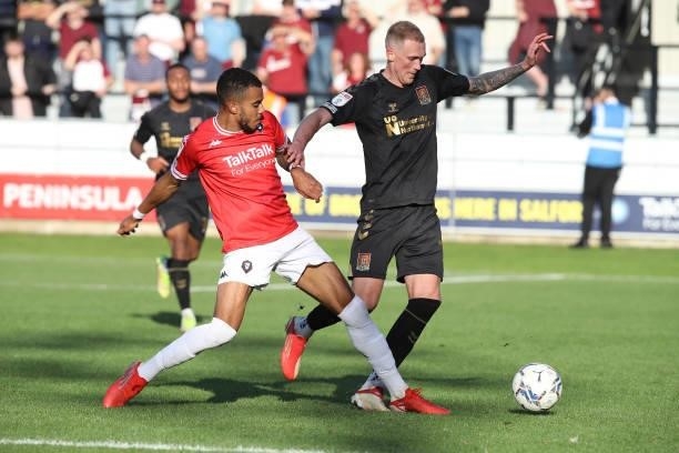Mitch Pinnock of Northampton Town attempts to move past Tyreik Wright of Salford City during the Sky Bet League Two match between Salford City and...