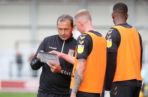 Northampton Town assistant manager Colin Calderwood gives instructions to Mitch Pinnock prior to coming on as a substitute during the Sky Bet League...