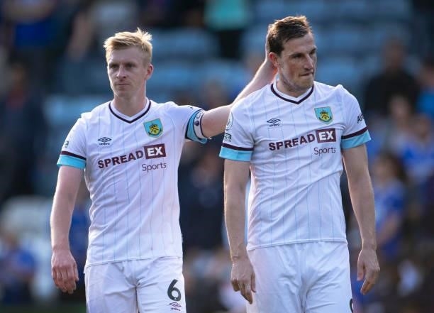 Ben Mee of Burnley consoles team mate Chris Wood after his late goal was disallowed after a VAR review during the Premier League match between...