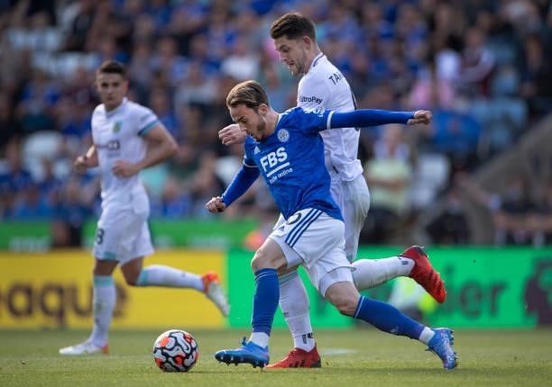 James Maddison of Leicester City and James Tarkowski of Burnley in action during the Premier League match between Leicester City and Burnley at The...