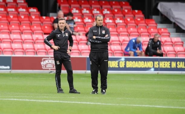 Northampton Town manager Jon Brady and his assistant Colin Calderwood look on prior to the Sky Bet League Two match between Salford City and...