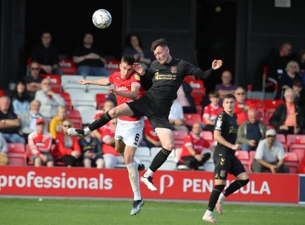 Paul Lewis of Northampton Town contests the ball with Matthew Lund of Salford City during the Sky Bet League Two match between Salford City and...