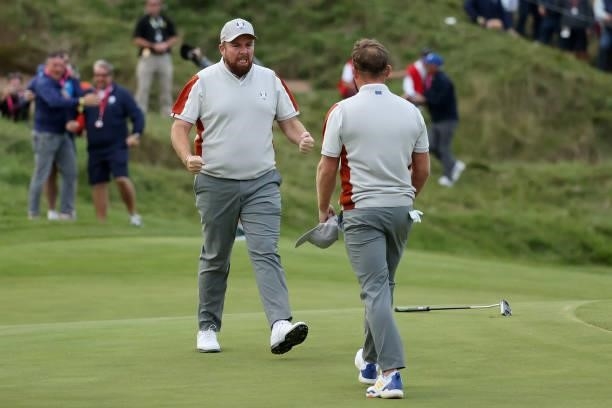 Shane Lowry of Ireland and team Europe and Tyrrell Hatton of England and team Europe celebrate their 1up win over Harris English of team United...