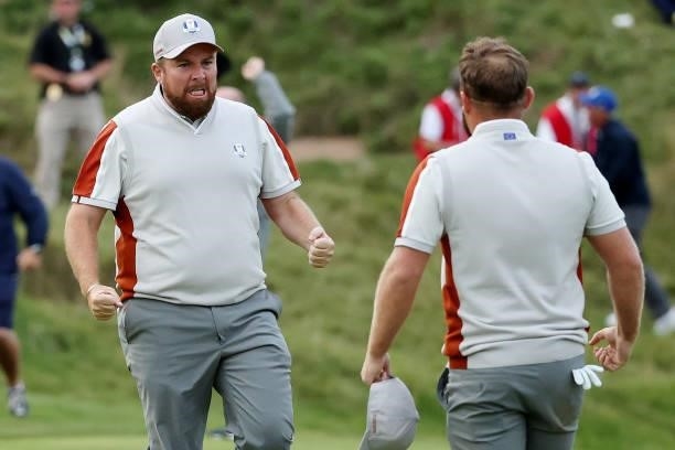Shane Lowry of Ireland and team Europe and Tyrrell Hatton of England and team Europe celebrate their 1up win over Harris English of team United...