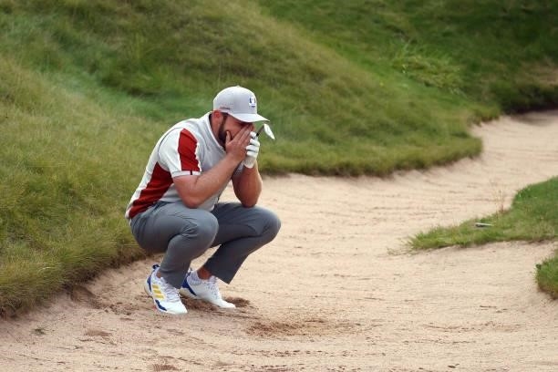 Tyrrell Hatton of England and team Europe reacts to his bunker shot on the 18th hole during Saturday Afternoon Fourball Matches of the 43rd Ryder Cup...