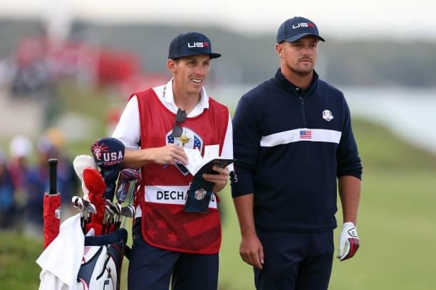 Bryson DeChambeau of team United States talks with his caddie Brian Zeigler during Saturday Afternoon Fourball Matches of the 43rd Ryder Cup at...
