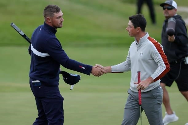 Bryson DeChambeau of team United States and Viktor Hovland of Norway and team Europe shake hands on the 17th green during Saturday Afternoon Fourball...