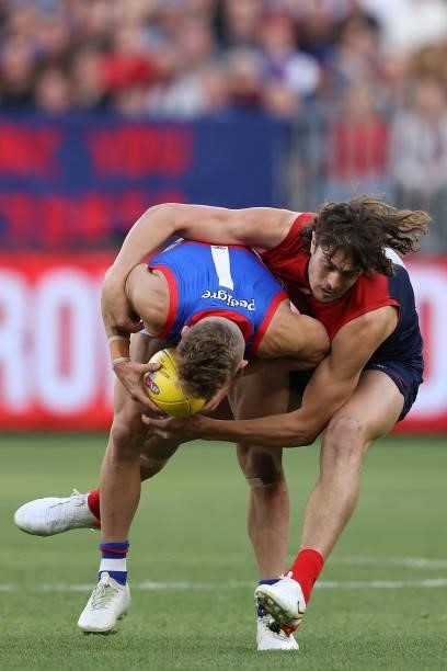Luke Jackson of the Demons tackles Adam Treloar of the Bulldogs during the 2021 AFL Grand Final match between the Melbourne Demons and the Western...