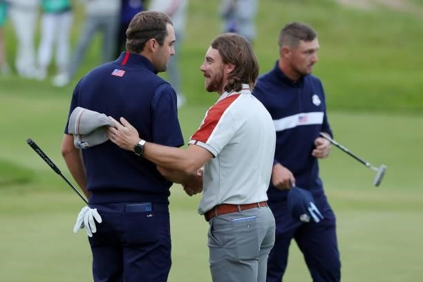 Scottie Scheffler of team United States and Tommy Fleetwood of England and team Europe shake hands on the 17th green during Saturday Afternoon...
