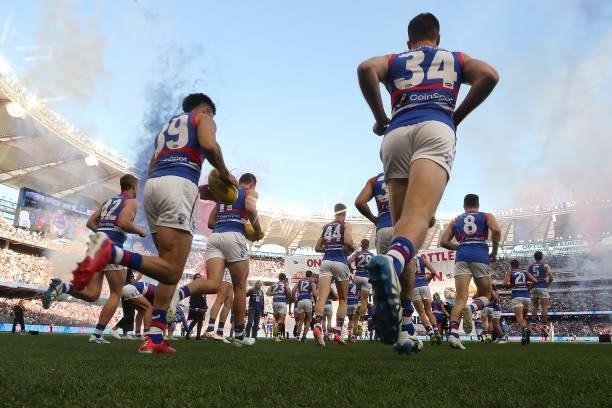 The Bulldogs run out onto the field during the 2021 AFL Grand Final match between the Melbourne Demons and the Western Bulldogs at Optus Stadium on...