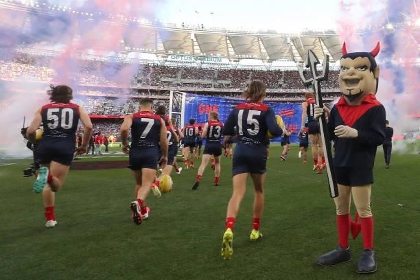 The Demons run out onto the field during the 2021 AFL Grand Final match between the Melbourne Demons and the Western Bulldogs at Optus Stadium on...