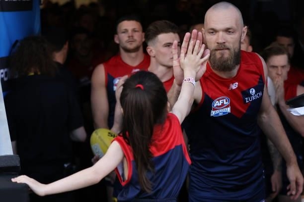 Max Gawn of the Demons high fives the junior mascot before leading the team onto the ground during the 2021 AFL Grand Final match between the...