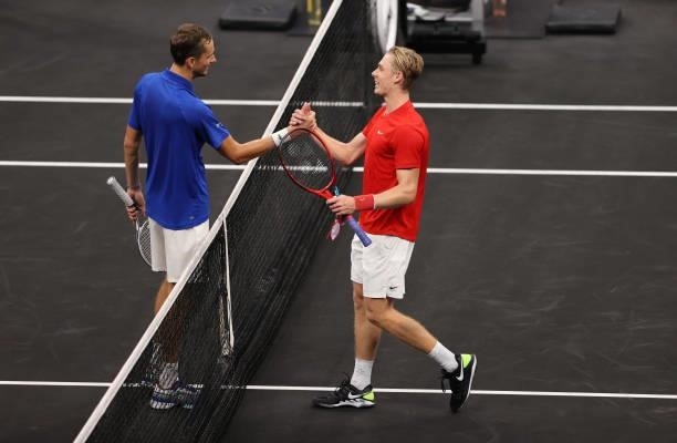 Denis Shapovalov of Team World shakes hands with Daniil Medvedev of Team Europe after the seventh match during Day 2 of the 2021 Laver Cup at TD...