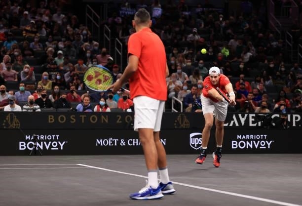 John Isner of Team World play a shot against Andrey Rublev and Stefanos Tsitsipas of Team Europe during the eighth matc during Day 2 of the 2021...