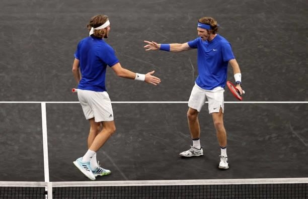 Andrey Rublev and Stefanos Tsitsipas of Team Europe react to a shot against John Isner and Nick Kyrgios of Team World during the eighth matchduring...