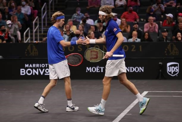 Andrey Rublev and Stefanos Tsitsipas of Team Europe react to a shot against John Isner and Nick Kyrgios of Team World during the eighth matchduring...