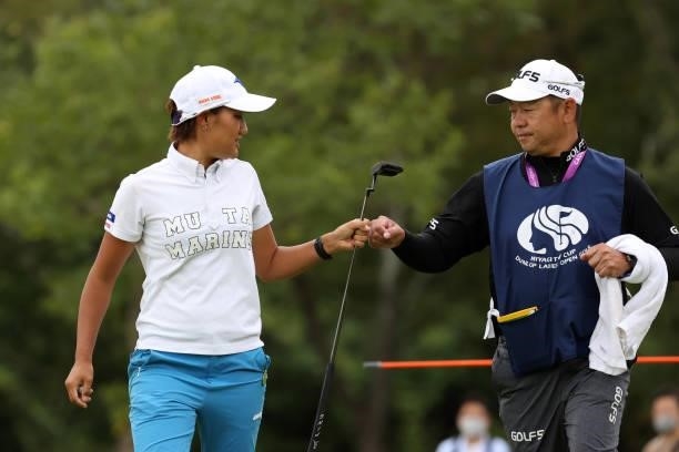 Mao Nozawa of Japan fist bumps with her caddie after the birdie on the 8th green during the final round of the Miyagi TV Cup Dunlop Ladies Open at...