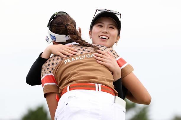 Yuna Nishimura of Japan is congratulated by Erika Hara after winning the tournament on the 18th green during the final round of the Miyagi TV Cup...
